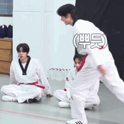 A Group Of Young Men Are Practicing Martial Arts And One Of Them Is Wearing A White Adidas Shirt GIF