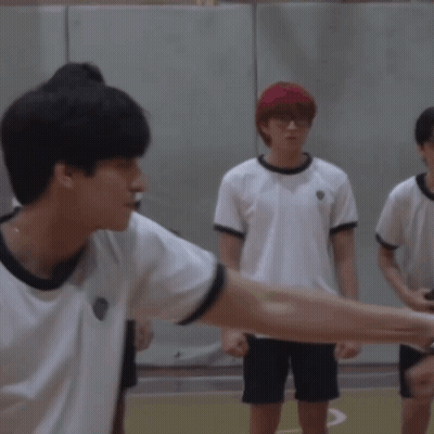 A Group Of Young Men Are Shaking Hands On A Court GIF