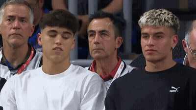 A Group Of Young Men Are Sitting In A Stadium And One Of Them Is Wearing A Puma Sweatshirt GIF