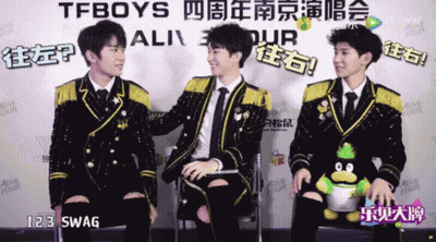 A Group Of Young Men Are Sitting In Front Of A Sign That Says Tfboys On It GIF