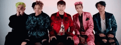 A Group Of Young Men Are Sitting Next To Each Other On A Couch . GIF