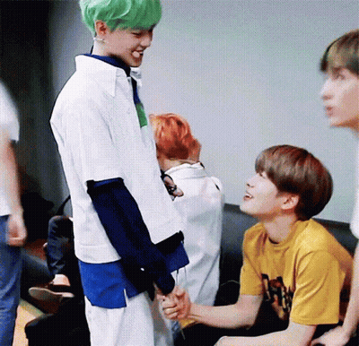 A Group Of Young Men Are Sitting On A Couch And One Of Them Has Green Hair . GIF