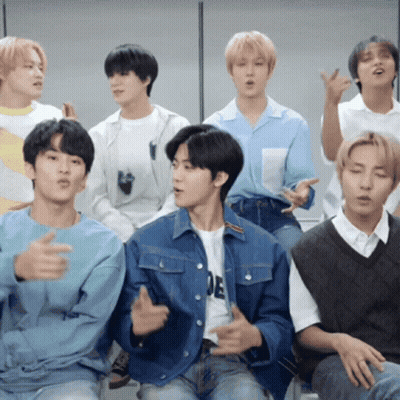 A Group Of Young Men Are Sitting Together And One Of Them Is Wearing A Shirt That Says ' E ' GIF