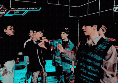 A Group Of Young Men Are Standing In A Dark Room With A Sign That Says Mcd Comeback Special Got7 GIF