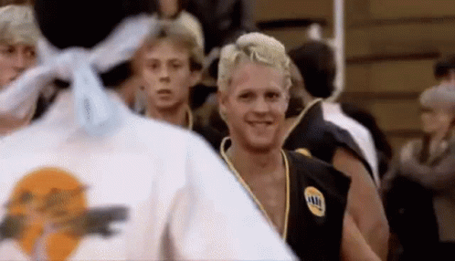 A Group Of Young Men Are Standing In A Gym . GIF