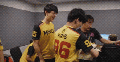 A Group Of Young Men Are Standing In A Room And One Of Them Is Wearing A Jersey With The Number 16 On It . GIF