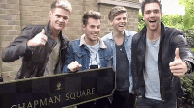 A Group Of Young Men Are Standing In Chapman Square Giving A Thumbs Up GIF