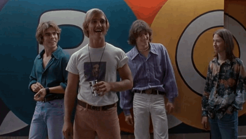 A Group Of Young Men Are Standing In Front Of A Wall That Says Yes They Do On It GIF