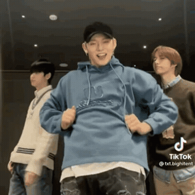 A Group Of Young Men Are Standing Next To Each Other And Dancing In A Room . GIF