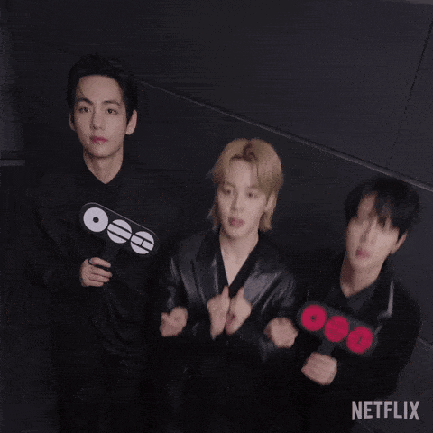 A Group Of Young Men Are Standing Next To Each Other And Holding Signs . GIF