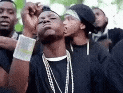A Group Of Young Men Are Standing Next To Each Other And Looking Up . GIF