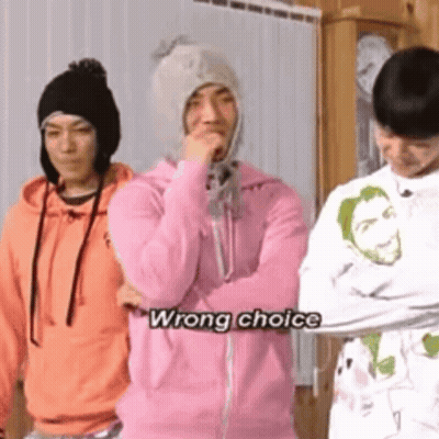 A Group Of Young Men Are Standing Next To Each Other And One Of Them Is Wearing A Pink Hoodie And A Hat . GIF