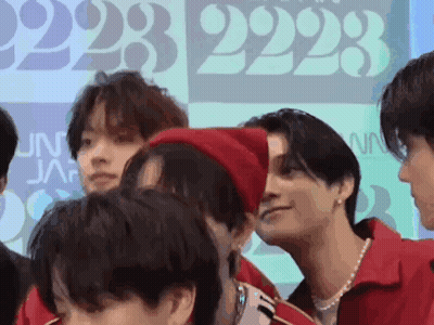 A Group Of Young Men Are Standing Next To Each Other And Talking . GIF