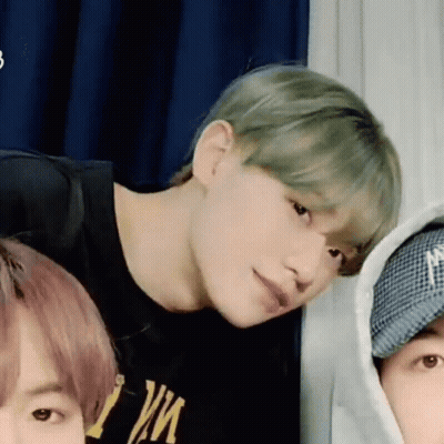 A Group Of Young Men Are Standing Next To Each Other In A Room And Looking At The Camera . GIF