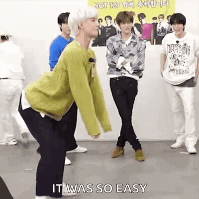 A Group Of Young Men Are Standing Next To Each Other On A Stage And One Of Them Is Dancing . GIF