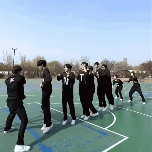 A Group Of Young Men Are Standing On A Basketball Court And One Of Them Has The Letter N On His Shirt GIF