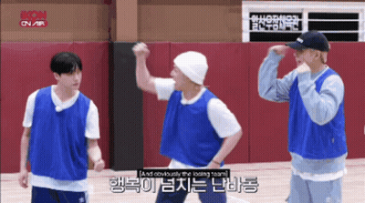 A Group Of Young Men Are Standing On A Basketball Court And One Of Them Is Wearing A Beanie GIF