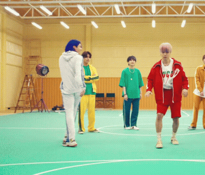 A Group Of Young Men Are Standing On A Basketball Court And One Of Them Is Wearing A Shirt That Says Gucci GIF