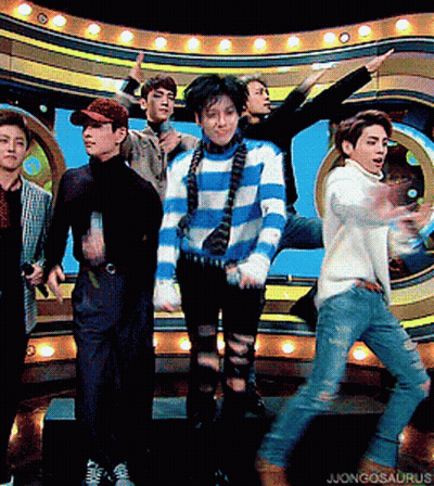 A Group Of Young Men Are Standing On A Stage With The Word Jongosaurus On The Bottom Right GIF