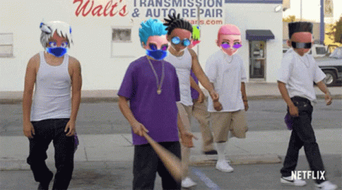 A Group Of Young Men Are Walking Down The Street In Front Of A Walt 'S Transmission And Auto Repair Store GIF