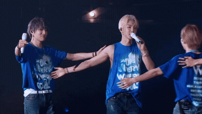A Group Of Young Men Hugging Each Other Wearing Blue Shirts With The Letter W On Them GIF