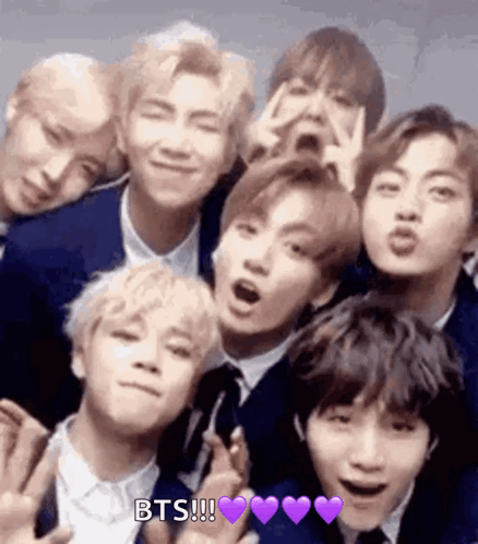 A Group Of Young Men In Suits And Ties Are Posing For A Picture Together . GIF