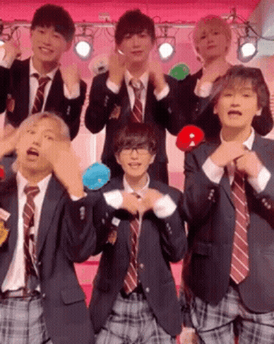 A Group Of Young Men In Suits And Ties Are Posing For A Picture . GIF