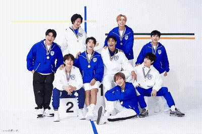 A Group Of Young Men Posing For A Picture With Medals Around Their Necks GIF