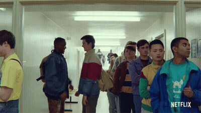 A Group Of Young Men Standing In A Hallway With A Netflix Logo On The Bottom GIF