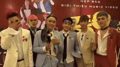 A Group Of Young Men Standing In Front Of A Sign That Says Hop Bao Giới Thiệu Music Video GIF