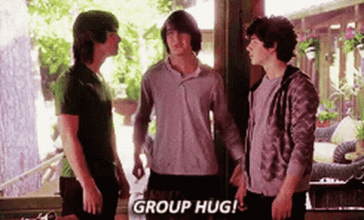 A Group Of Young Men Standing Next To Each Other In A Room . GIF