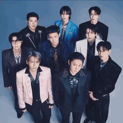 A Group Of Young Men Standing Next To Each Other In Suits And Ties . GIF