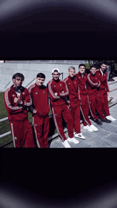 A Group Of Young Men Wearing Red Adidas Tracksuits Pose For A Picture GIF