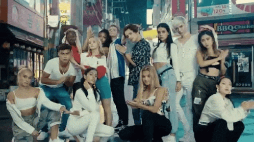 A Group Of Young People Are Posing For A Picture In Front Of A Bbq Shop GIF