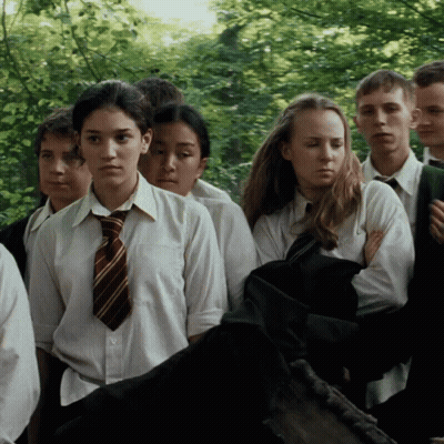 A Group Of Young People Are Standing In A Line GIF