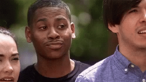 A Group Of Young People Are Standing Next To Each Other . GIF