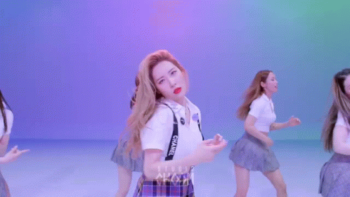 A Group Of Young Women Are Dancing In Front Of A Sign That Says Room GIF