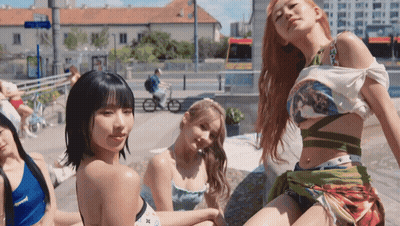 A Group Of Young Women Are Posing For A Picture In Front Of A City Street GIF