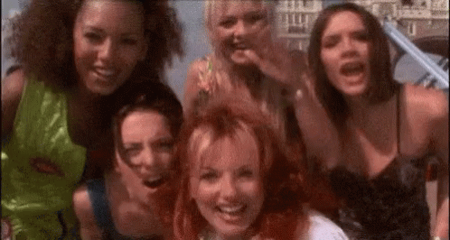 A Group Of Young Women Are Posing For A Picture Together . GIF