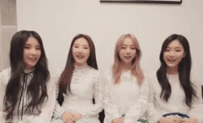 A Group Of Young Women Are Sitting Next To Each Other And Smiling GIF