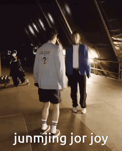 A Guess Shirt Is Being Worn By A Man GIF