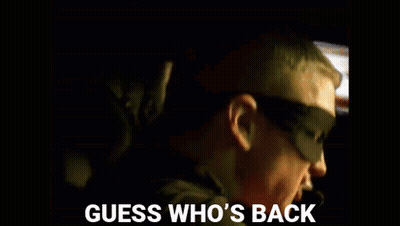 A Guess Who 'S Back Poster With A Man And A Child In The Background GIF