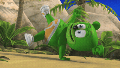 A Gummy Bear Is Doing A Handstand On A Beach GIF
