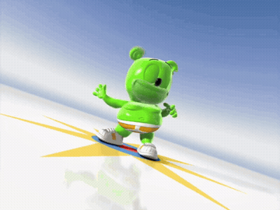 A Gummy Bear Is Riding A Snowboard Down A Hill GIF