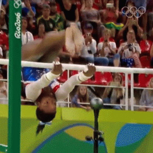 A Gymnast Is Doing A Handstand In Front Of A Crowd At The Rio 2016 Games GIF