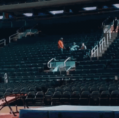 A Gymnast Is Jumping Over A Mat In A Stadium GIF