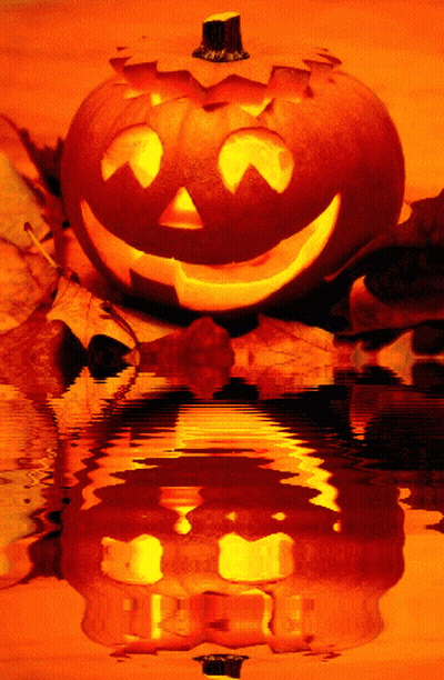 A Halloween Pumpkin With A Face Carved Into It Is Reflected In A Body Of Water GIF