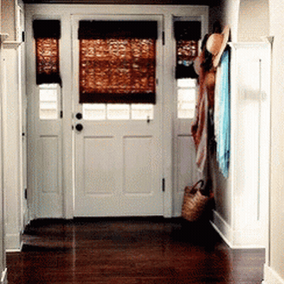 A Hallway With A White Door And A Wicker Basket On The Floor GIF