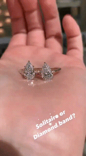 A Hand Holding A Diamond Ring With The Words Solitaire Or Diamond Band GIF
