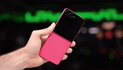 A Hand Holding A Pink And Black Cell Phone GIF